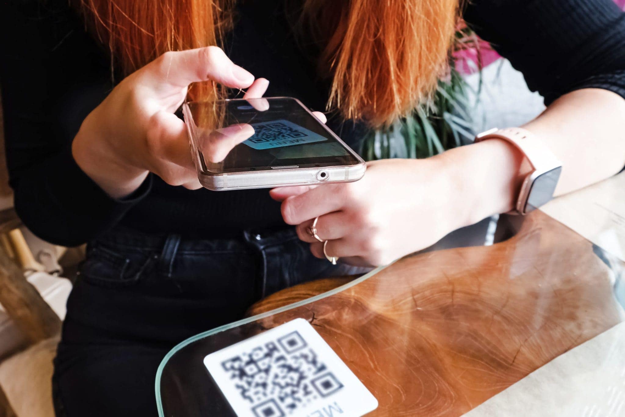 woman scanning the barcode qr code in restaurant MAGNSN9 scaled 1